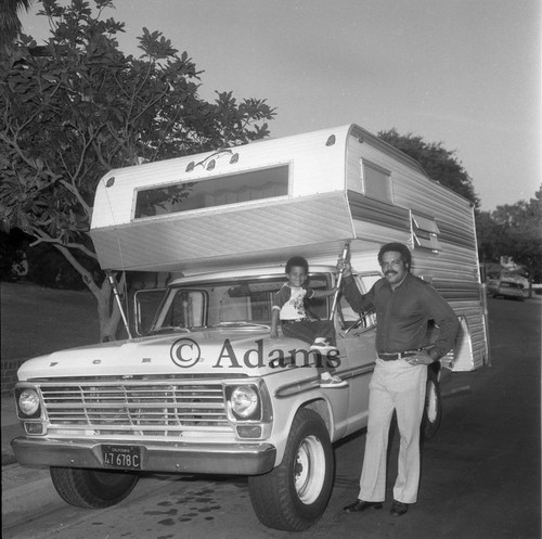 Man and boy standing next to RV, Los Angeles, 1975