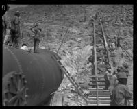 Crews work to fix a damaged section of the Los Angeles Aqueduct in No-Name Canyon, Inyo County vicinity, [about 1927]
