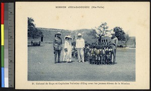 Military officers pose with mission children, Ouagadougou, Burkina, Faso, ca.1920-1940