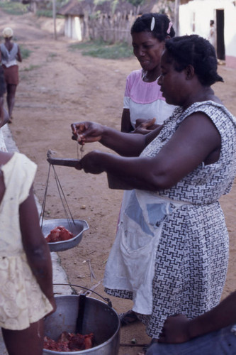 Woman weighing meat on a scale, San Basilio de Palenque, 1976