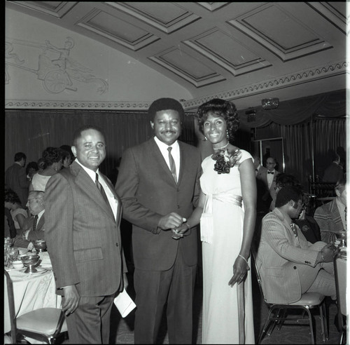 Doris Davis posing with two men at a special event, Los Angeles, 1973