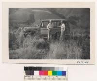 Max Cory and Wes Humphrey in grass plot, Black Star Canyon burn of 1948, Orange County. Brush treated with chemical in this place to kill sprouts. Good growth of grass. Smile and Harding grass. Seedling was done by airplant. Nov. 1951