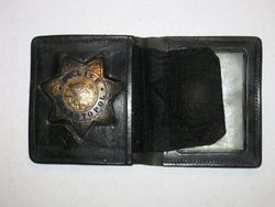 Sebastopol Police Officer Lemual "Shorty" Plumley's police badge in black wallet