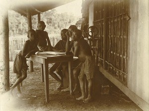 Children reading a book, in Gabon