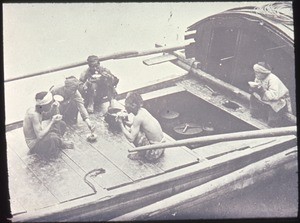 Four men and a woman eating on the deck of a boat, Changde, Hunan, China, ca.1900-1919