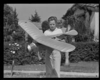 Frank Uecker holds a model plane for the Times-Richfield-Jimmie Allen model building contest, Glendale, 1935