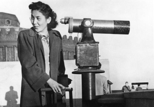 Woman near a telescope