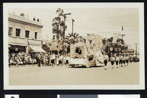 Float and marchers in a parade, ca.1920