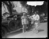 Two oil well fire fighters in their asbestos suits at Santa Fe Springs, Calif. oil wells fire in 1928