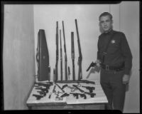 Deputy Sheriff James J. Claxton displays his private gun collection, Los Angeles, 1935