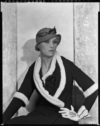 Peggy Hamilton modeling a dark colored dress or coat with light fur trim, circa 1931