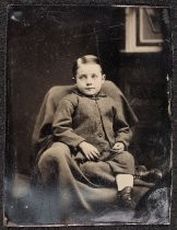 Portrait of child seated in chair