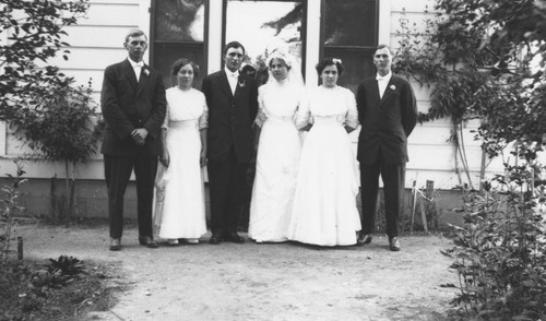 Wedding group portrait of William Morner and wife, Annie, with members of the wedding party, 1913