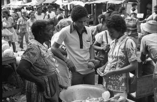 Woman selling fruits at a market, Cartagena Province, 1975