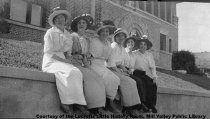 Women seated in front of library, 1911