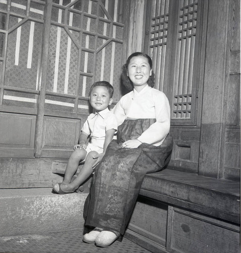 Woman and boy posing indoors