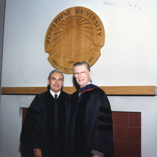 Robert Hood and Chancellor Runnels beneath the Pepperdine University seal