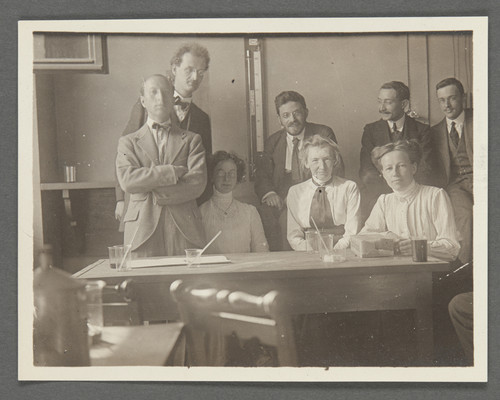 [Group photo in laboratory, probably in Prague. Paul Ehrenfest, fourth from left, with beard.]