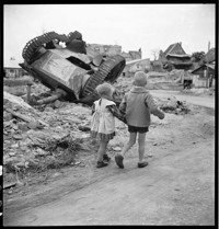[Miscellaneous: two small children walk past over-turned tank in village ruins, [Small house with bomb damage, Ammerschwihr?]