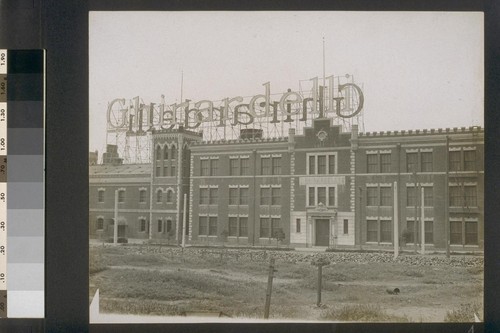 [Factory buildings with "Ghirardelli" sign across rooftops. South facade.]