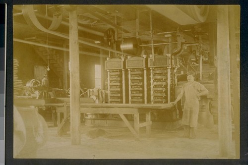 [Factory worker at table.]