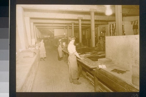 [Factory workers in packaging area.]