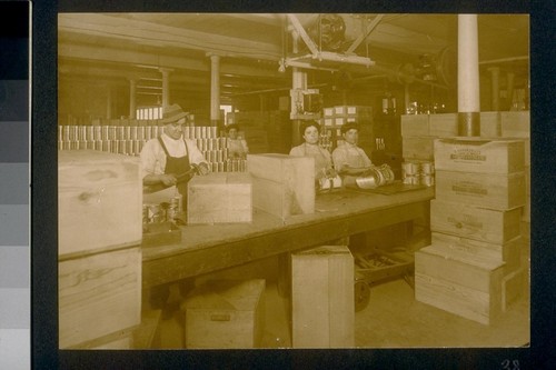 [Factory workers in packaging area.]