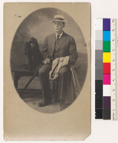 [George Shaw posing with dog.]