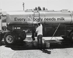 Unidentified man washing a milk truck at the California Cooperative Creamery, about 1983