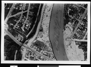 Aerial view of unidentified flooded area, showing patches of dry mud on parts of the city, 1938