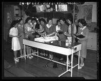 Marian Manners demonstrates "American cooking" for Japanese American women at Young Buddhist League, 1941