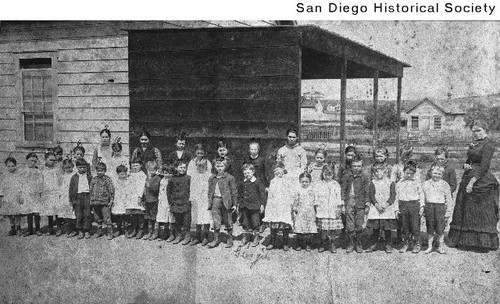 Group of children and their teacher outside the Pink School