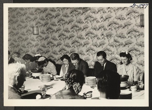 Representatives of New York City's Japanese American organizations saying grace at a dinner given in honor of Harold S. Fistere