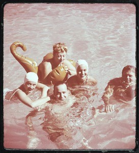 Milner family party, 2 men & 2 women floating in a swimming pool, Ojai, Calif., ca. 1950s
