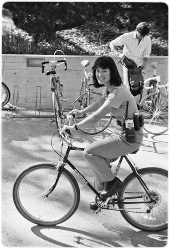 Campus police officer checking bicycles in front of Geisel Library