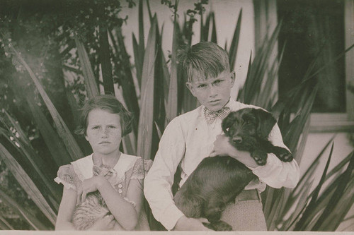 Two children of the Clearwater family with a cat and a dog in Pacific Palisades, Calif