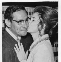Edward J. Garcia. Caption reads, "Ed Garcia gets a kiss from his wife, Joanne." Garcia had been sworn in as a municipal court judge
