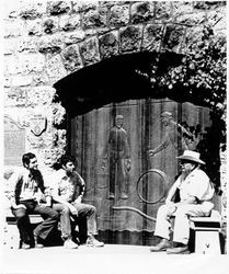 Sam, Don and father August Sebastiani sit beside the newly carved main doors at Sebastiani Vineyards
