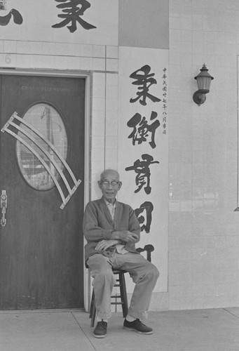 Chinese man sitting outside Chinese Free Masons, from Walnut Grove