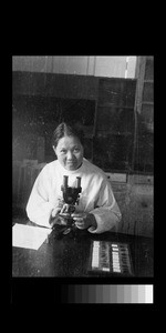 Dr. Rosemary Huang with microscope, Chengdu, Sichuan, China, ca.1946