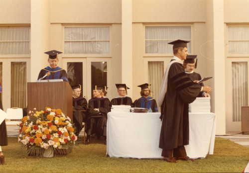 Dean Frank Pack and President Banowsky presenting diplomas to the Graduating Graduate Students