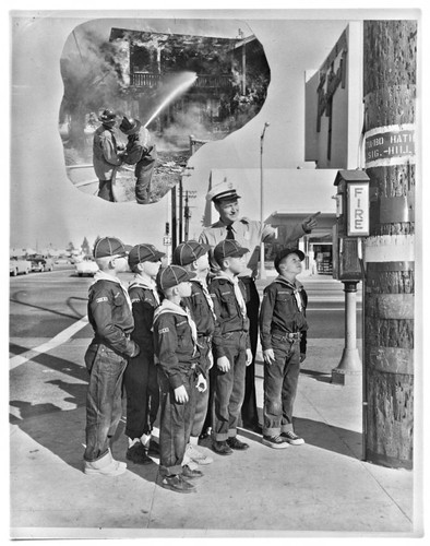 Cub Scouts standing at a fire alarm box located on Bellflower and Stearns St