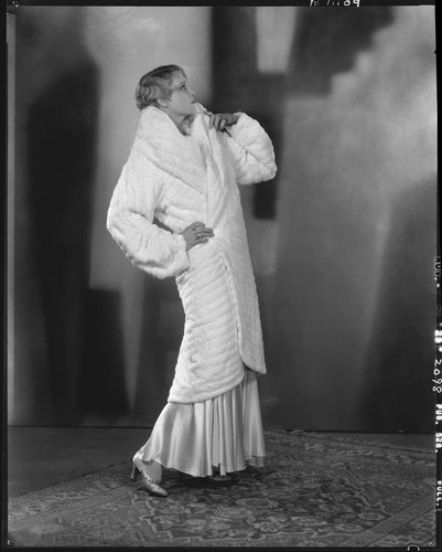 Peggy Hamilton modeling a white ermine coat, 1929