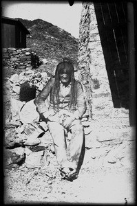 Portrait of a Mojave Indian sitting near an adobe wall, ca.1885