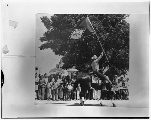 Patrol man on horse holding Arkansas flag