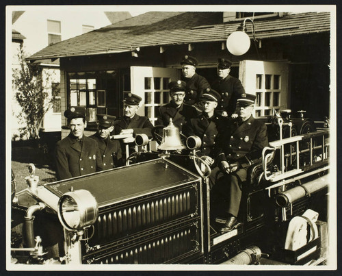 Firefighters in dress uniform on Fire Engine No. 2 outside Station No. 2, 1929 Appleton St