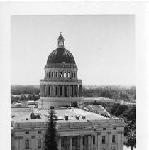 Elevated view of the California State Capitol building. View is looking south during painting. Note the windows are out on the dome