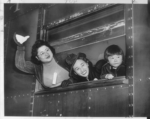 "No tearful farewells marked the exodus yesterday. Smiling at prospect of new, exciting life, Japs waved good-by to a Los Angeles they won't see for duration."--caption on photograph