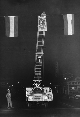 Hanging Banners for Anaheim's Centennial Celebration. [graphic]