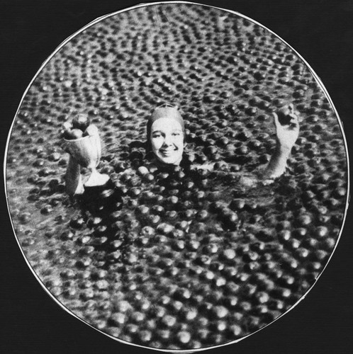 Miss Jessie Darnley swims way to title of Miss Anaheim in pool filled with 3 tons of Oranges on April 23, 1929. [graphic]